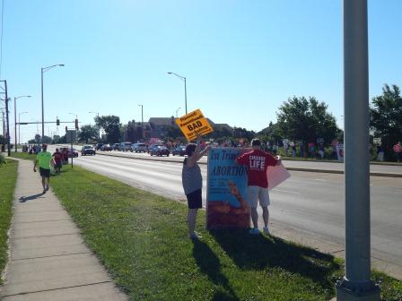 9:00 CST AM- The protest begins along E. New York St., Oakhurst Dr. intersection, Aurora, IL